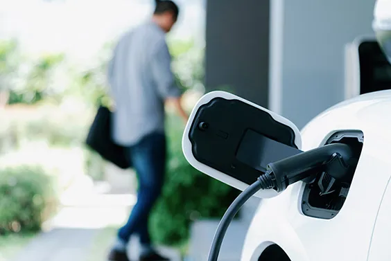 Person charging car at home