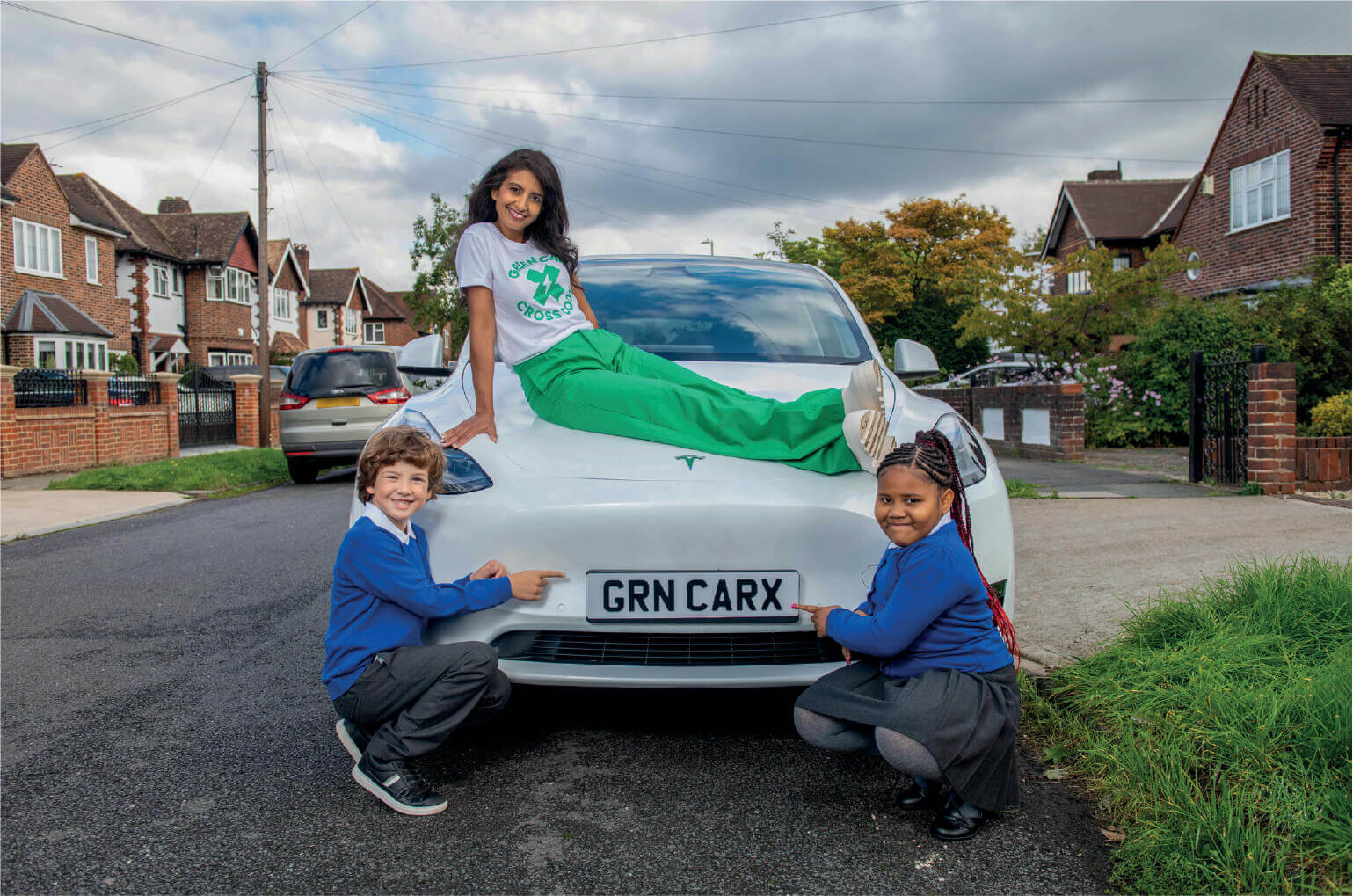 Konnie Huq sat on car bonnet promoting Green Car Cross Code campaign