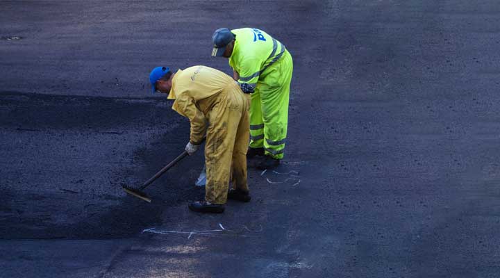 roadside workers fixing a pothole.