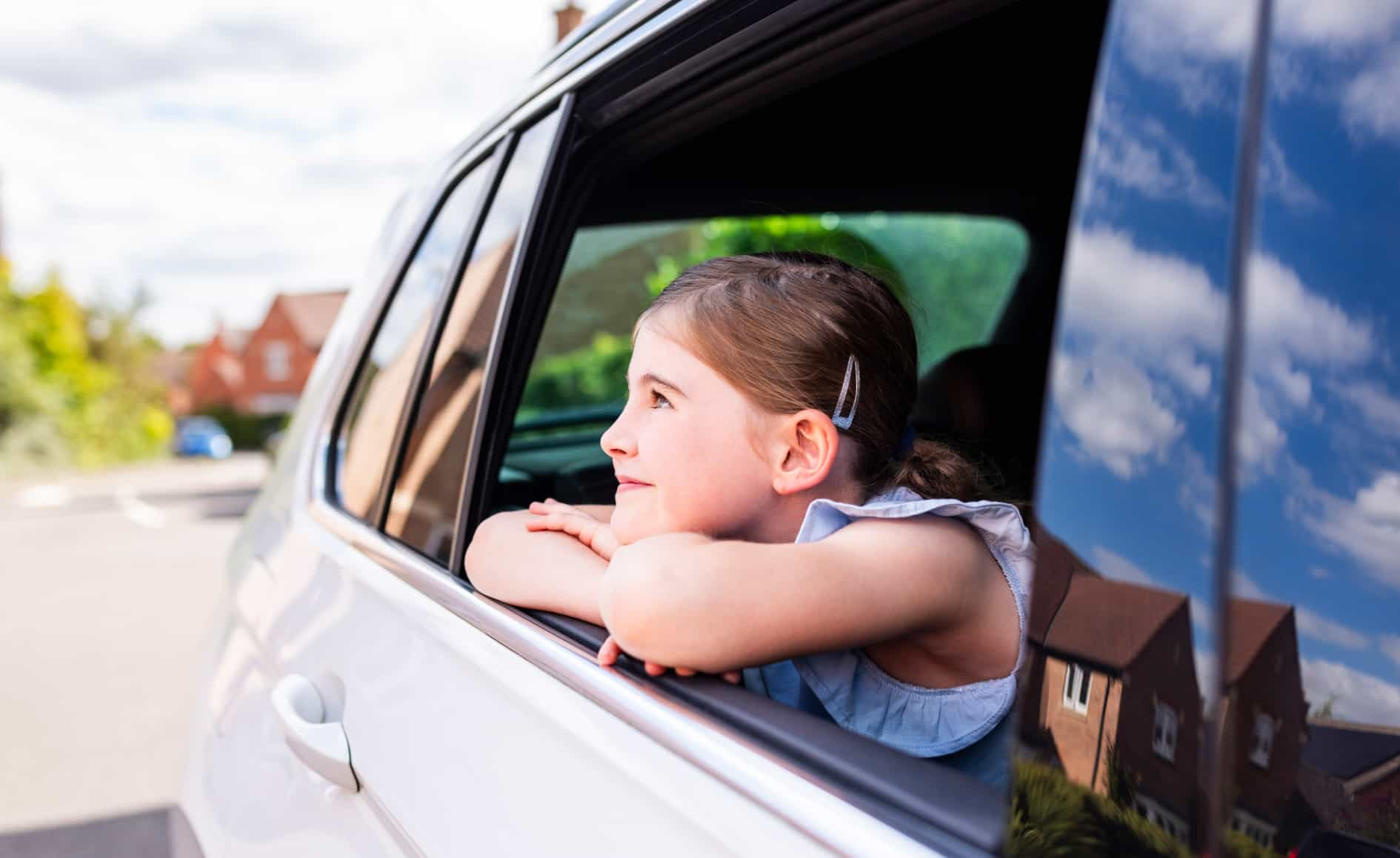 Young girl looking out of the car window with ambition