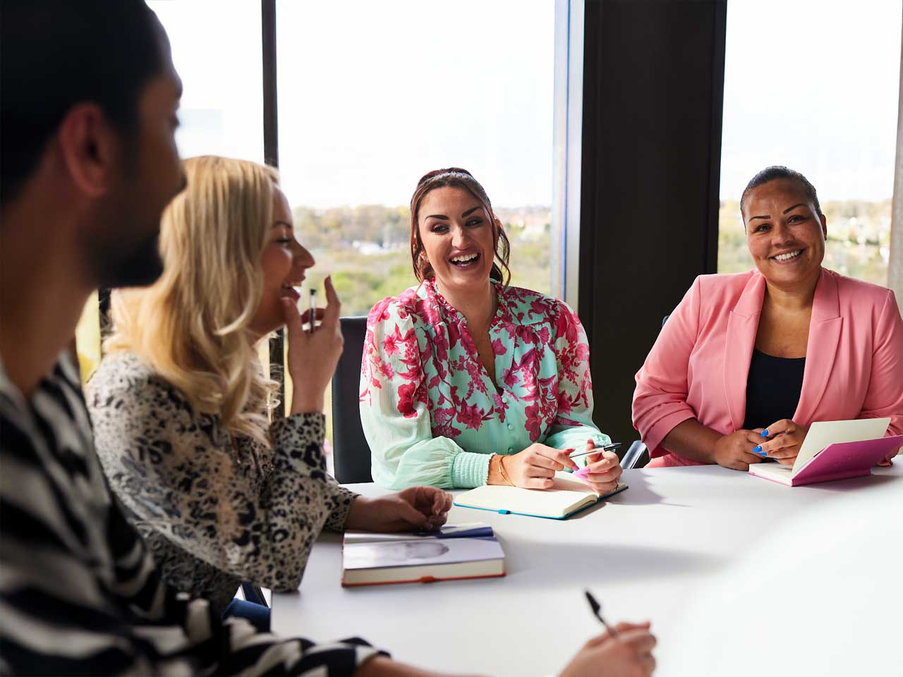 Image of colleagues interacting around the table