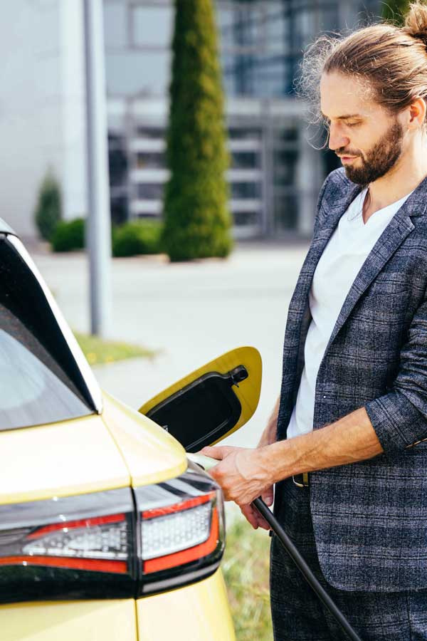 man charging ev car