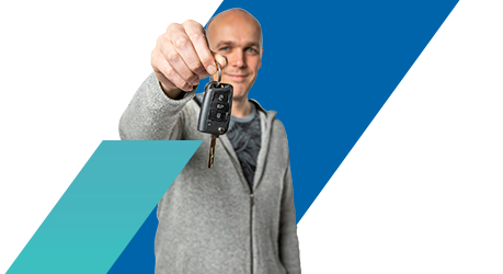 Adam holding up a car key front facing towards the camera
