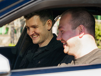Two of Zenith sales team colleague looking at the interior specification of a vehicle.