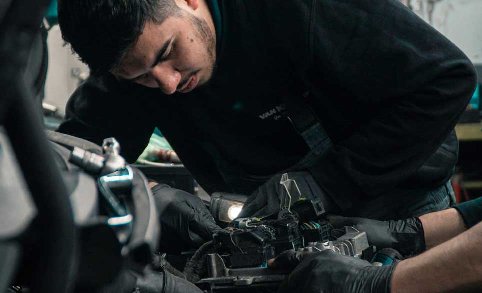 garage worker fixing car