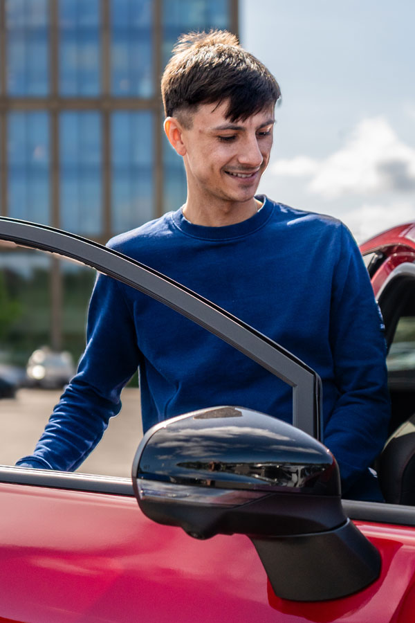 someone getting into a new car