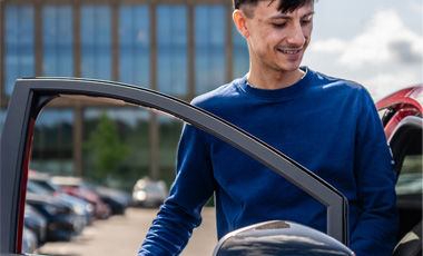 someone getting into a new car