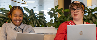 two staff members discussing work.