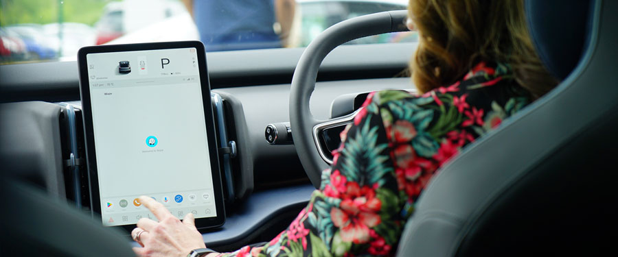 lady sat in the front seat using car interface.