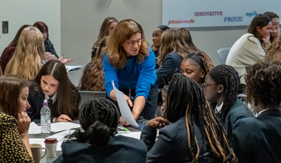 Teacher helping students