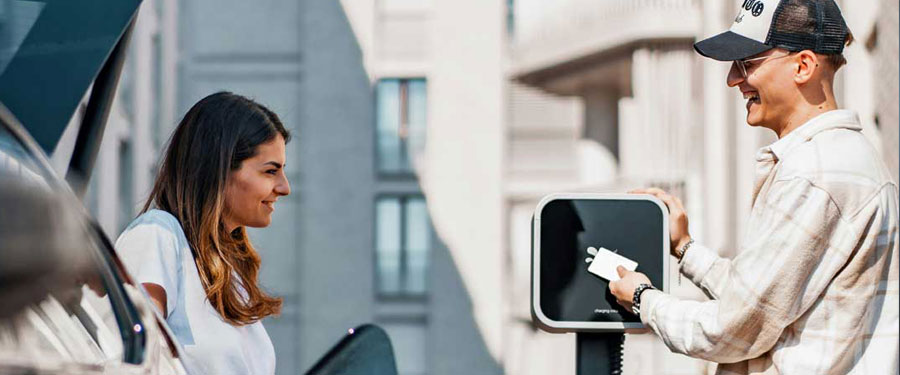 young couple charging the car