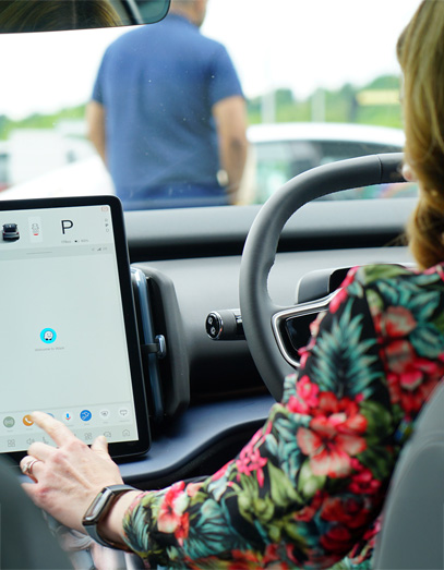 person using the touchscreen in the car
