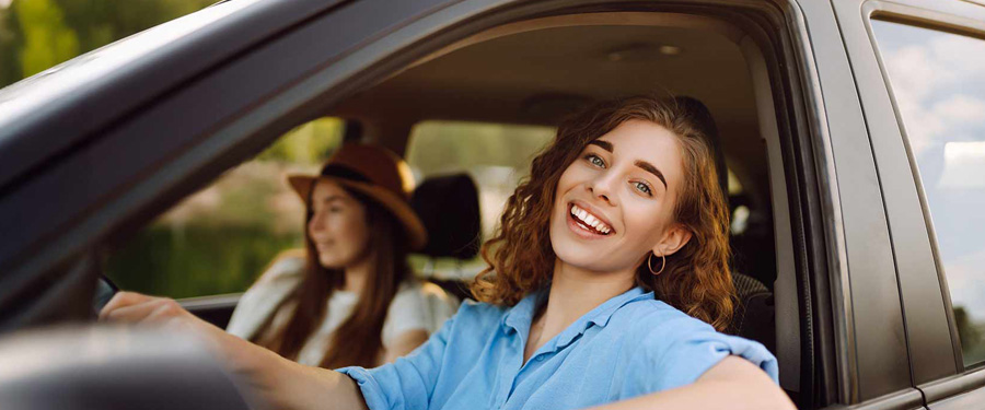 Lady sat in the car with the window down.
