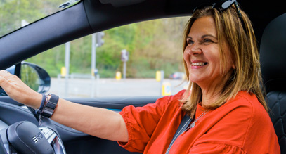 lady looking into the rear view mirror