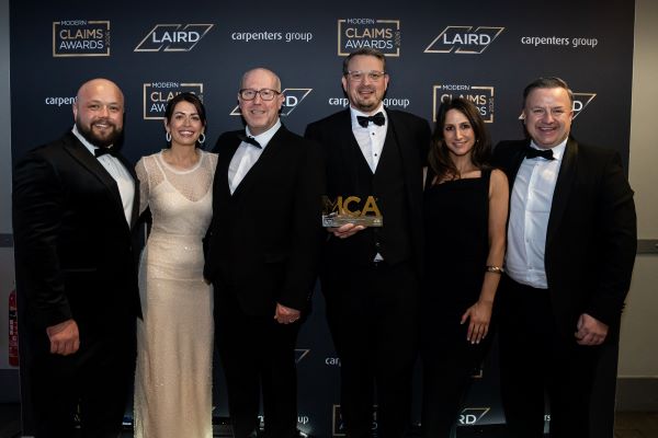 Team Zenith collecting their Modern Claims Award