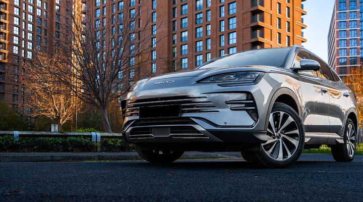 BYD in front of city skyline.