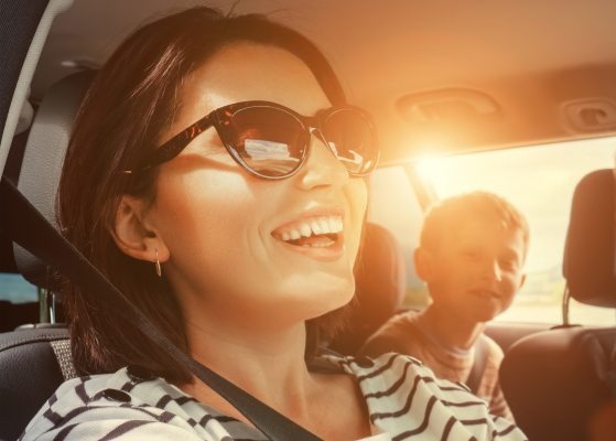 Family happily driving in a leased vehicle