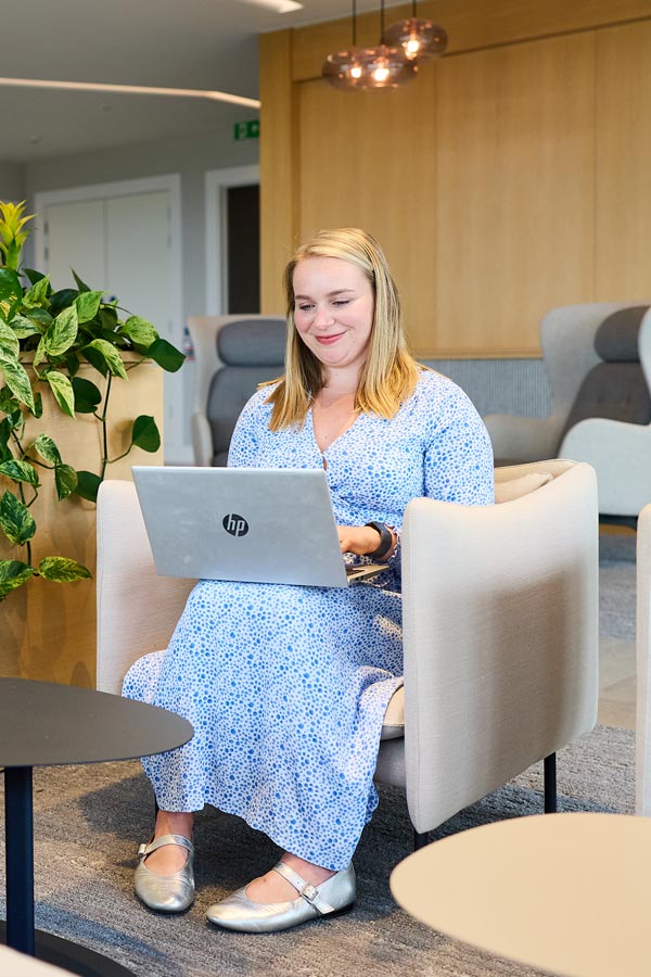 lady sitting in a chair working.