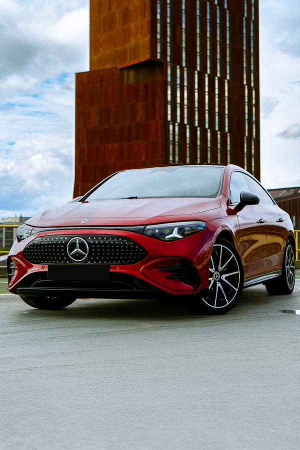 Mercedes cla Infront of a urban building.