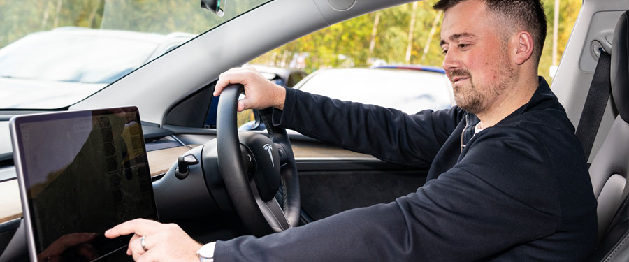 Person using the touchscreen in the car